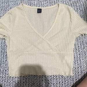 I believe this is a ribbed fabric but is a cross over crop top.